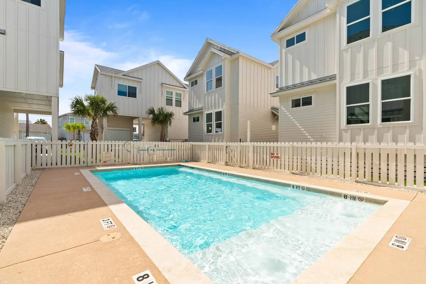 Relax and refresh at the shared pool, conveniently located right behind the house, perfect for a quick dip anytime during your stay.