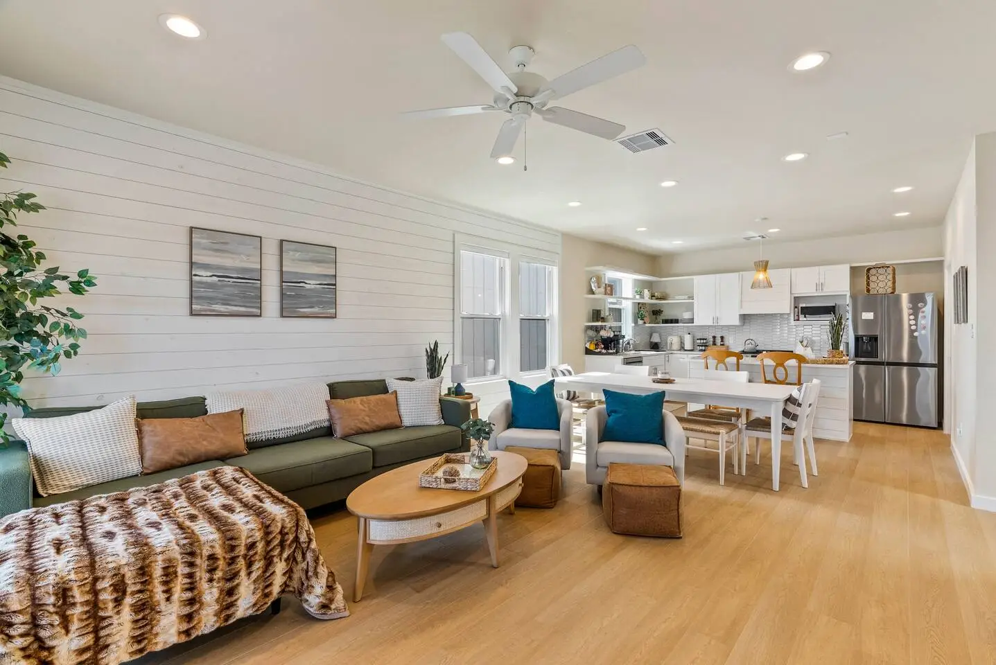 Bright open living! Co-located on the second floor with the kitchen and a powder room is a spacious open-plan layout with comfy sectional and large dining area, ideal for gathering with family and